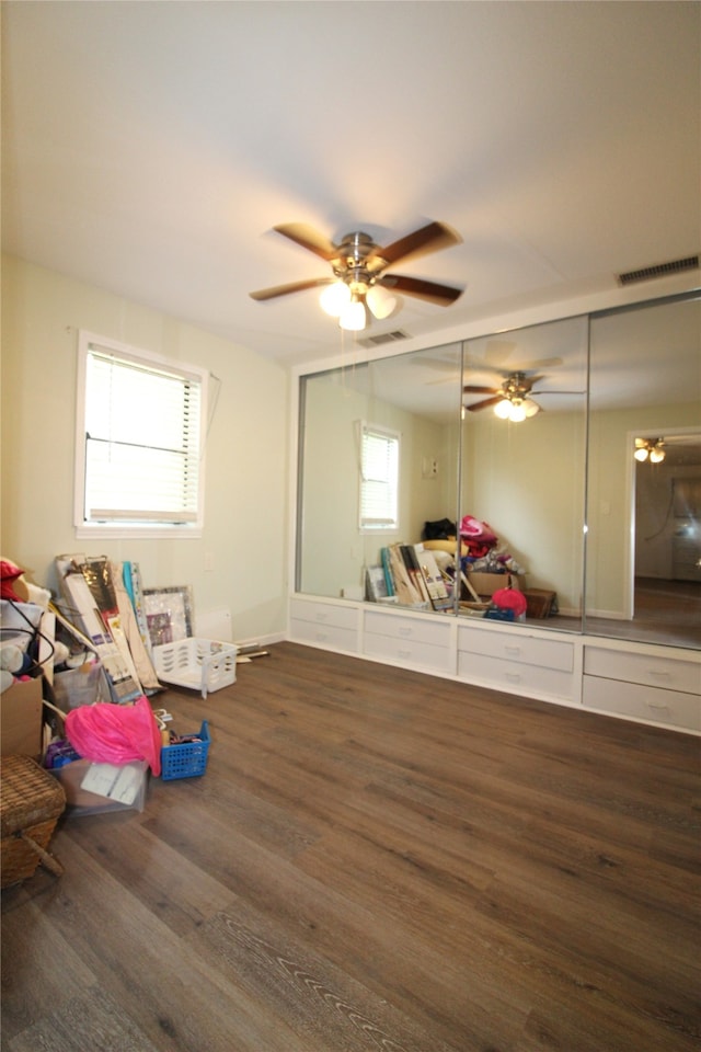 interior space featuring ceiling fan, plenty of natural light, and dark hardwood / wood-style floors