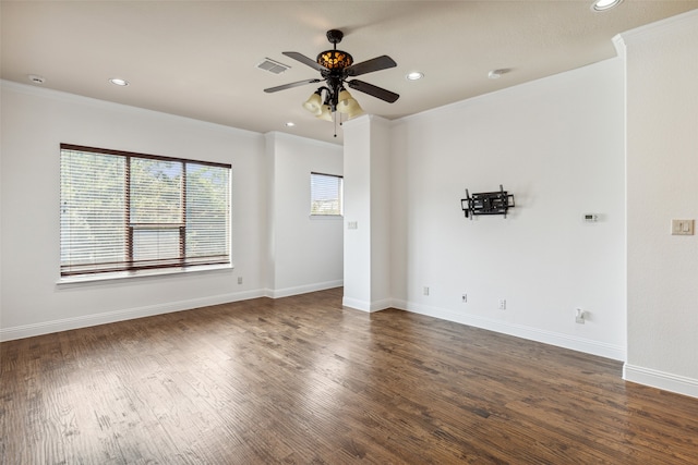 spare room with crown molding, dark wood-type flooring, and ceiling fan