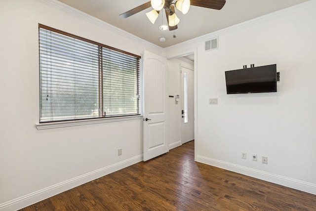 interior space featuring crown molding, a healthy amount of sunlight, ceiling fan, and dark hardwood / wood-style floors