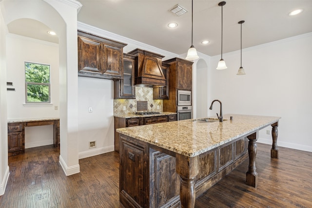 kitchen featuring premium range hood, stainless steel appliances, sink, and dark brown cabinetry