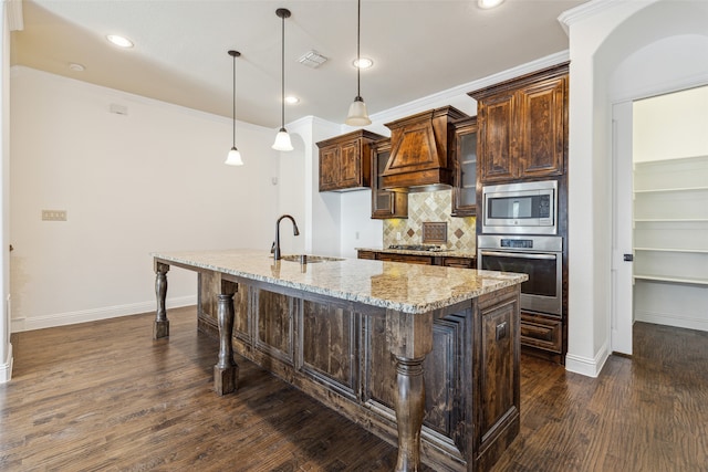 kitchen with a kitchen bar, sink, light stone countertops, dark hardwood / wood-style floors, and appliances with stainless steel finishes