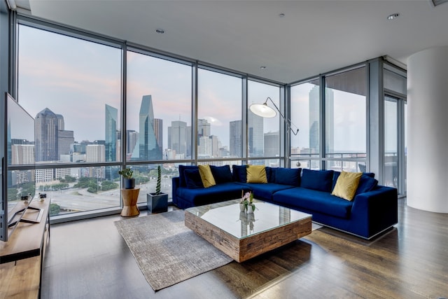 living room with hardwood / wood-style floors, expansive windows, and plenty of natural light