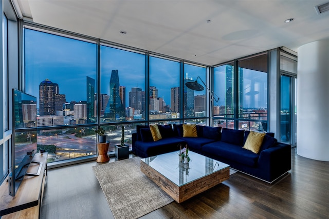 living room with a wall of windows and wood-type flooring