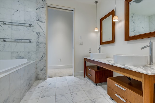 bathroom with vanity and tiled tub