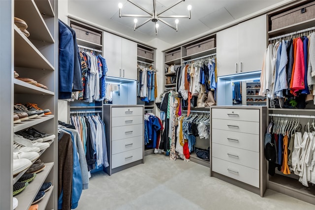 walk in closet with light colored carpet