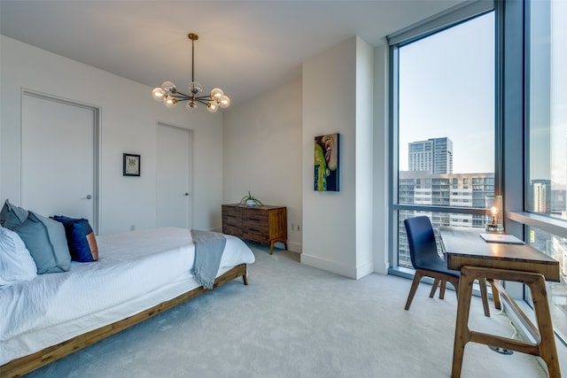 carpeted bedroom featuring an inviting chandelier and multiple windows