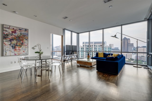 living room with dark hardwood / wood-style floors, a healthy amount of sunlight, and floor to ceiling windows