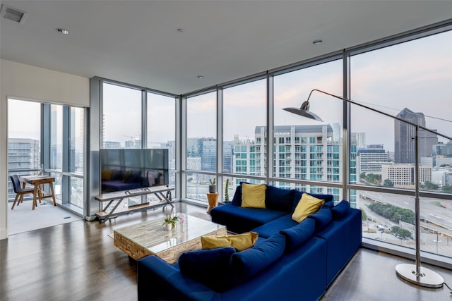 living room with a wall of windows and hardwood / wood-style flooring