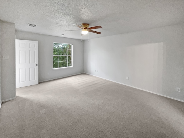 unfurnished room with light carpet, a textured ceiling, and ceiling fan