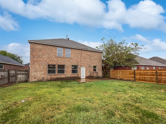 back of property featuring a patio area and a lawn