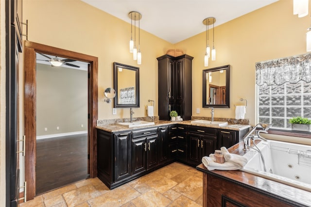 bathroom featuring wood-type flooring, vanity, a tub, and ceiling fan