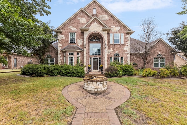 view of property featuring a front lawn