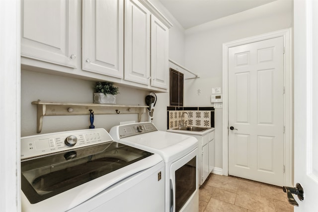 washroom with separate washer and dryer, sink, light tile patterned floors, and cabinets