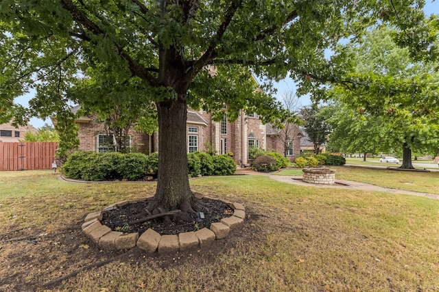 view of front facade with a front yard and an outdoor fire pit