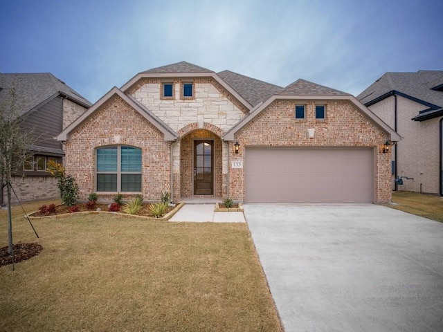 view of front of home with a front yard and a garage