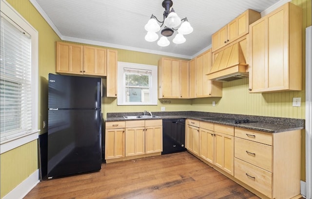 kitchen with custom range hood, sink, light brown cabinets, and black appliances