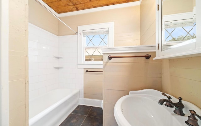 bathroom with tile patterned flooring, a healthy amount of sunlight, sink, and tiled shower / bath