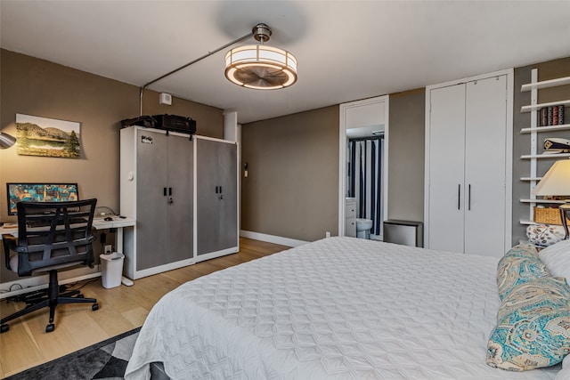 bedroom featuring light hardwood / wood-style flooring and ensuite bathroom