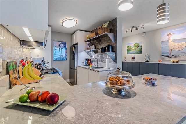 kitchen with stainless steel appliances, sink, and white cabinets