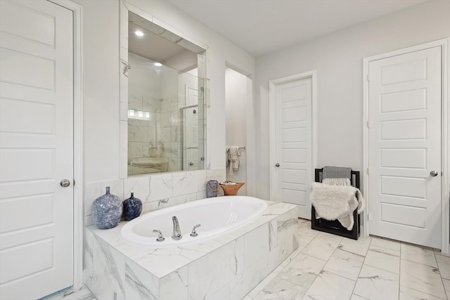 bathroom featuring shower with separate bathtub