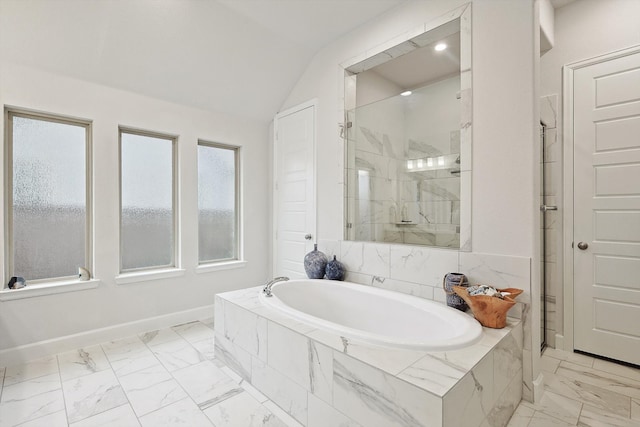 bathroom featuring independent shower and bath and lofted ceiling