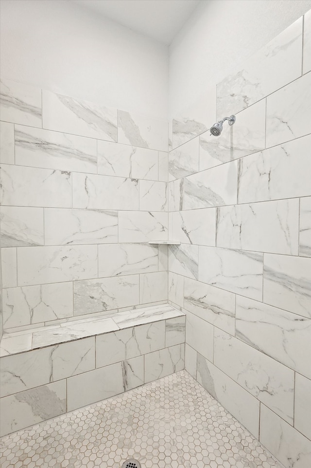 bathroom with tiled shower