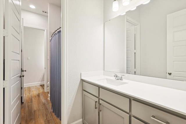 bathroom with vanity and hardwood / wood-style floors