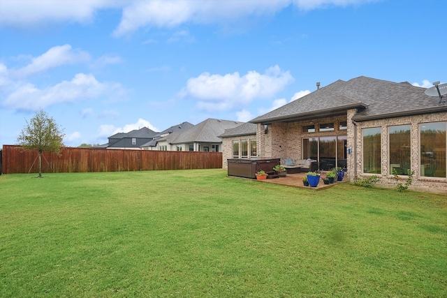 view of yard featuring a hot tub and a patio area