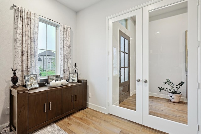 doorway to outside with light hardwood / wood-style flooring and french doors