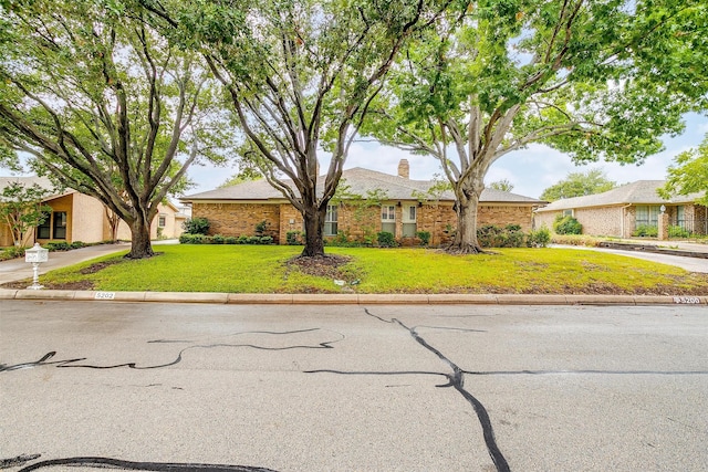 ranch-style home featuring a front yard