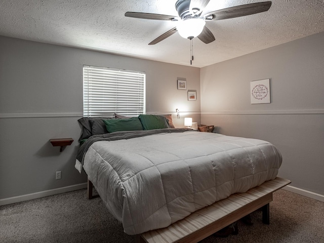 carpeted bedroom with a ceiling fan, a textured ceiling, and baseboards