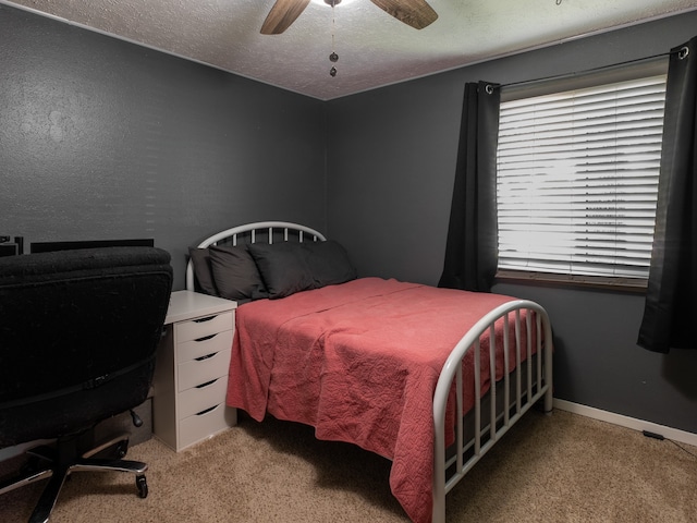 bedroom with a textured ceiling, carpet flooring, and ceiling fan