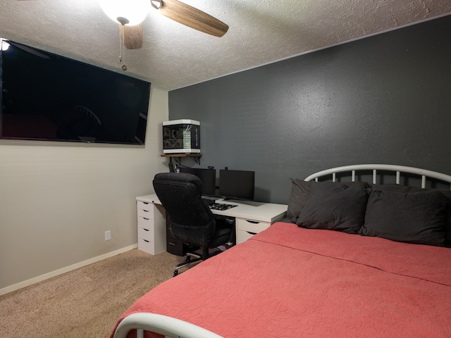 carpeted bedroom featuring a textured ceiling and ceiling fan