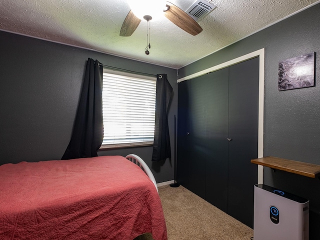 bedroom with light carpet, a textured wall, and a textured ceiling