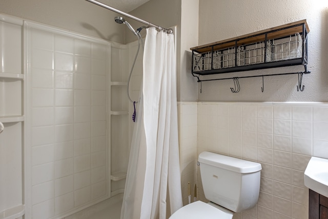 bathroom featuring tile walls, toilet, a shower with curtain, and vanity