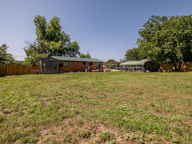 view of yard with a storage shed and a carport