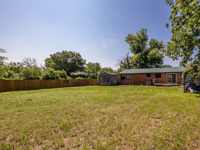 view of yard with cooling unit and a storage shed