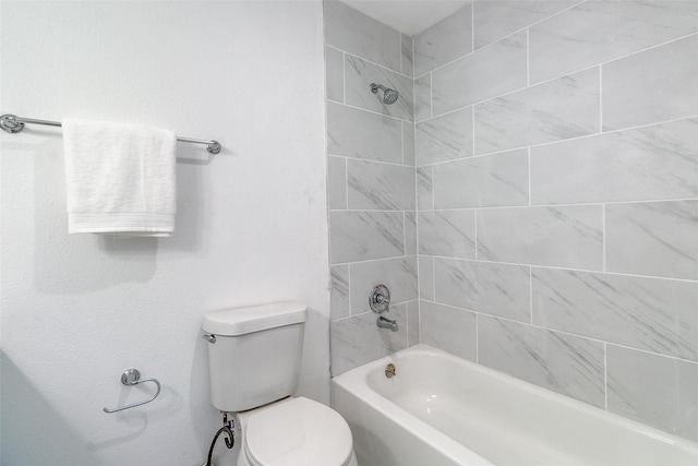 bathroom with toilet and tiled shower / bath combo