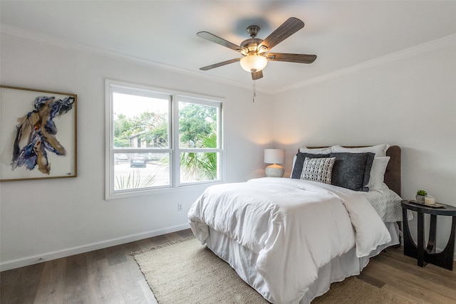 bedroom featuring ornamental molding, ceiling fan, and wood-type flooring