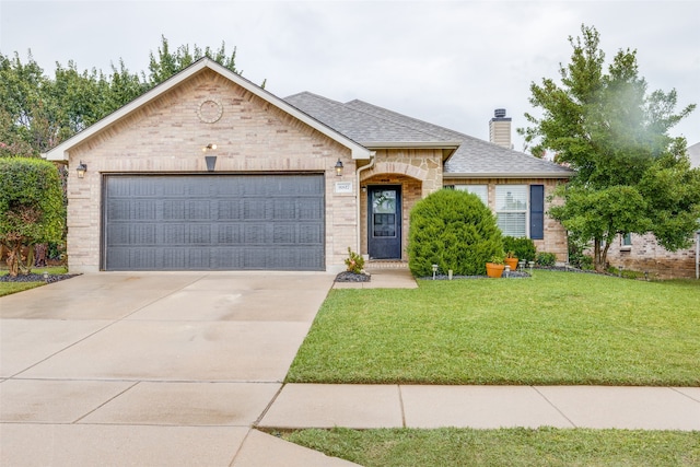 view of front of house with a front yard and a garage