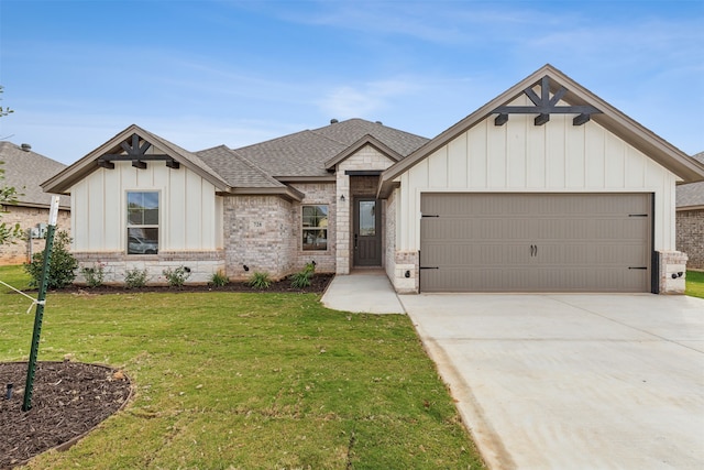 modern farmhouse style home with a front yard and a garage