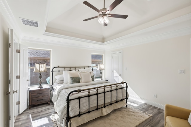 bedroom with multiple windows, ceiling fan, and light hardwood / wood-style floors