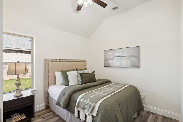 bedroom featuring ceiling fan, hardwood / wood-style floors, and vaulted ceiling