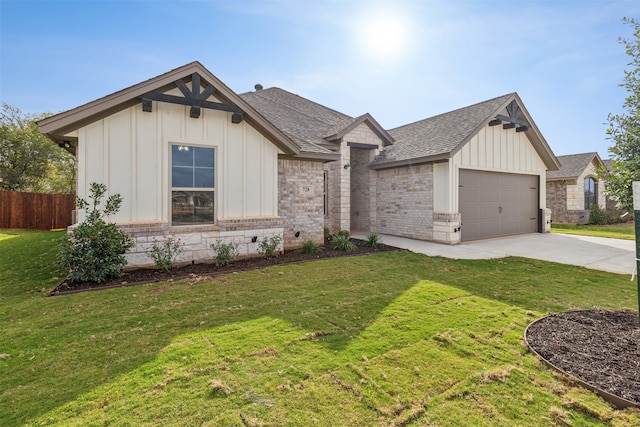 view of front of property featuring a garage and a front lawn