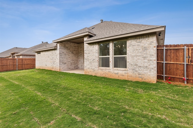 back of house with a yard