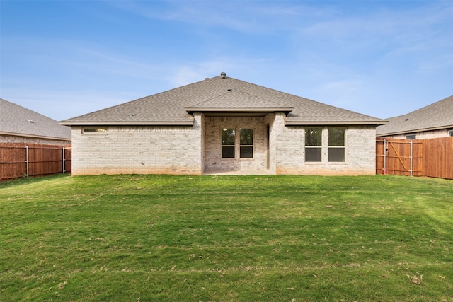 rear view of property with a lawn