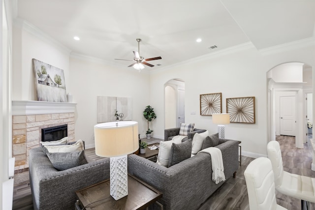 living room with ceiling fan, ornamental molding, and dark wood-type flooring