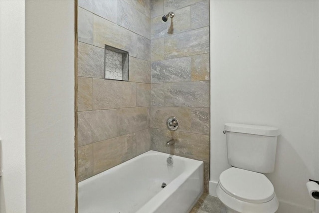 bathroom featuring toilet and tiled shower / bath