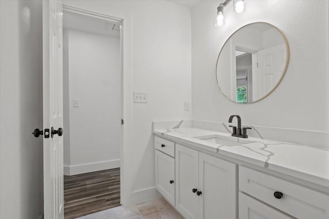 bathroom with hardwood / wood-style floors and vanity