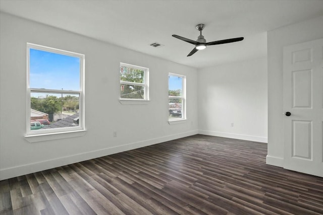 empty room with ceiling fan and dark wood-type flooring